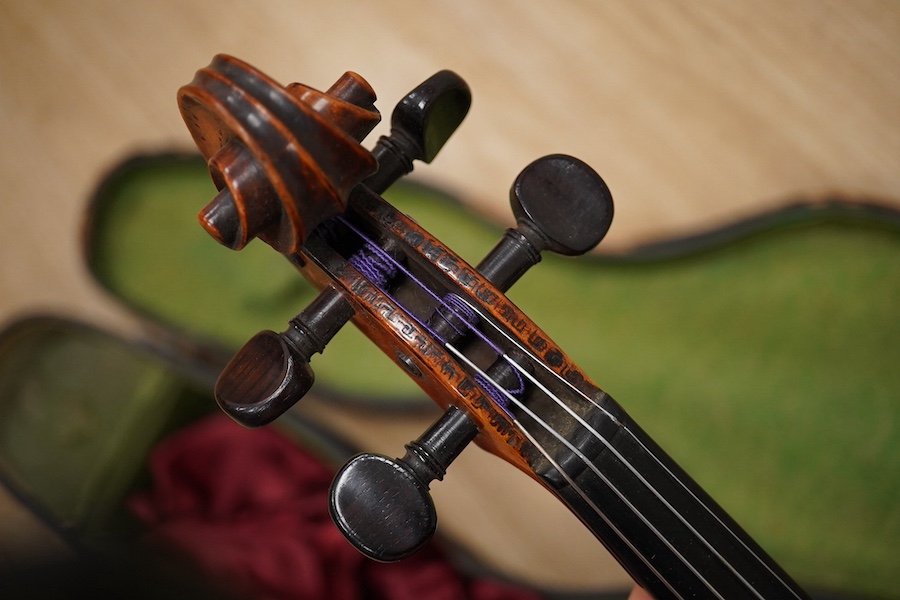 A late 19th century German violin from the Mittenwald region, body length 36cm, in a contemporary case. Condition - fair to good, condition of the case - poor.